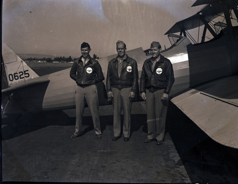 Cadets posing with PT-13 Stearman trainer