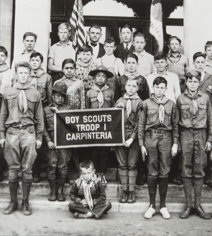 Carpinteria Boy Scout Troop with Kenji and Tom Ota in front of Carpinteria Union School : 1926. Kenji left of banner, Tom directly behind banner.