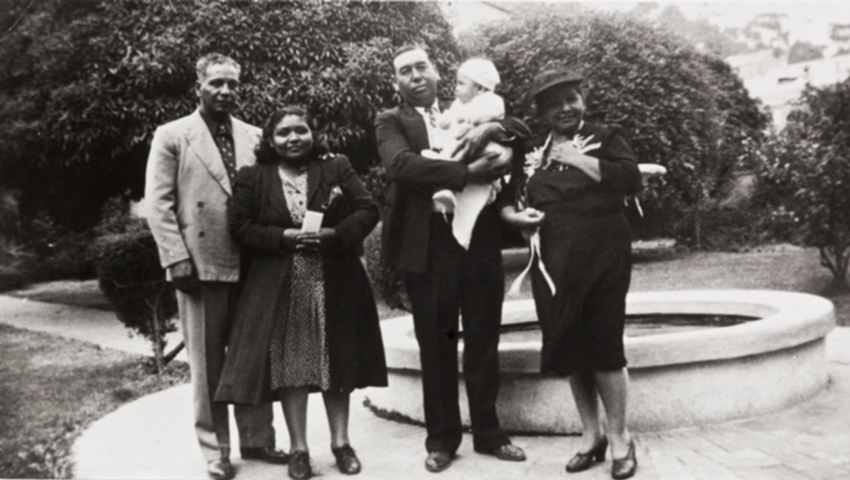 Sisters Margaret (left) and Bertha Tumamait with their husbands, Raymond John Durante and Joe Blanco holding Jerome Duarte at his baptism at Old San Buenaventura Mission : October 14, 1945.